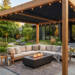 Modern outdoor living room featuring a pergola, sectional sofa, fire pit, and comfortable patio seating.